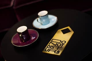 Do not disturb sign in gold and black