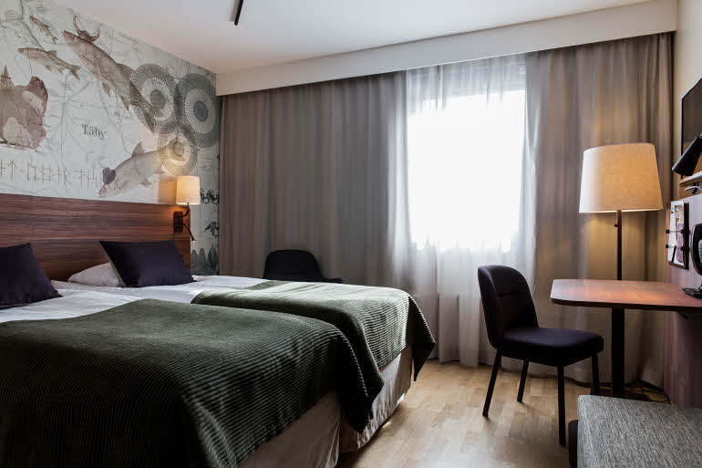 Beds and desk in Standard Family room at Scandic Täby