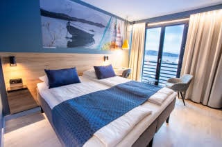 Room with queen bed and window